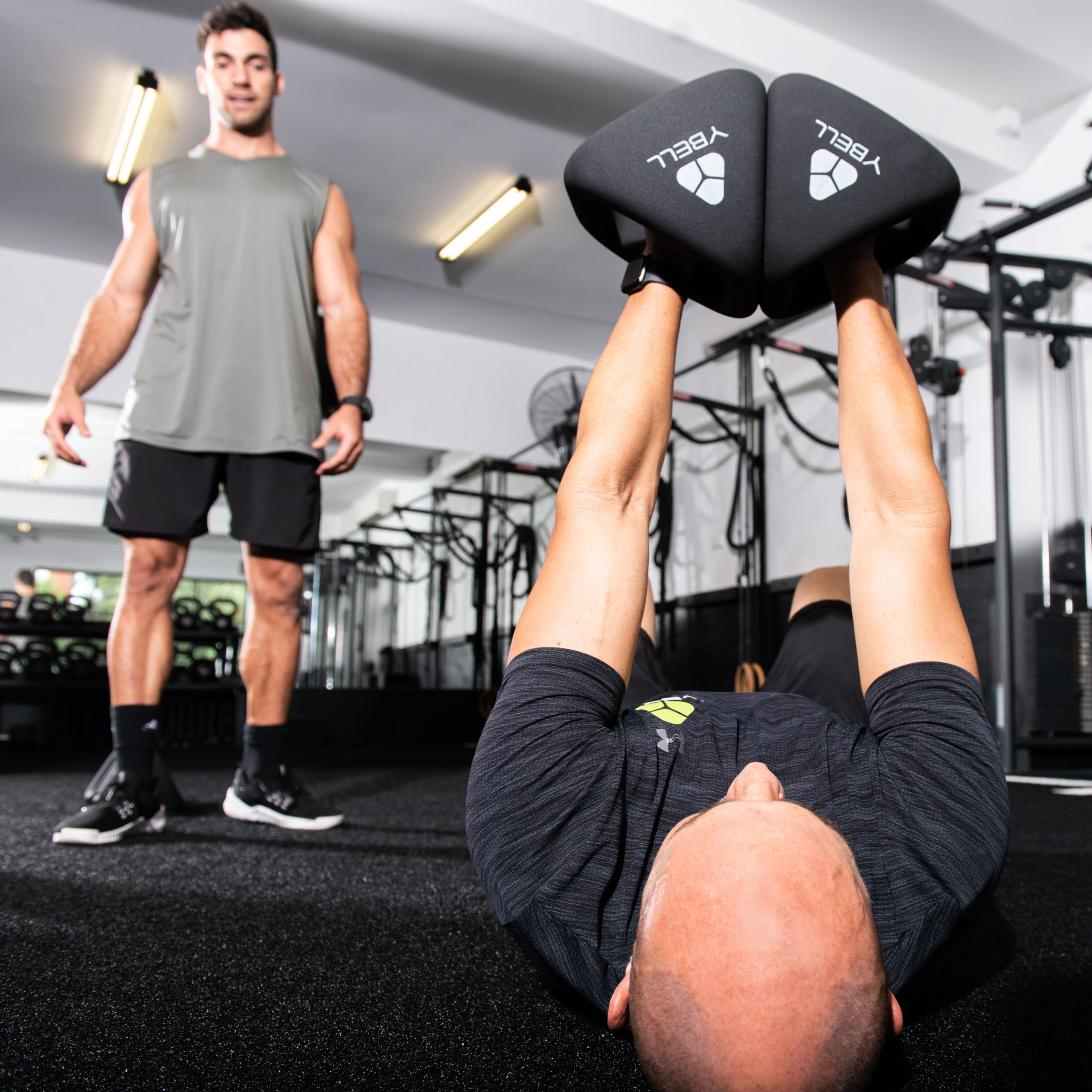 2 male athletes performing chest fly with YBell